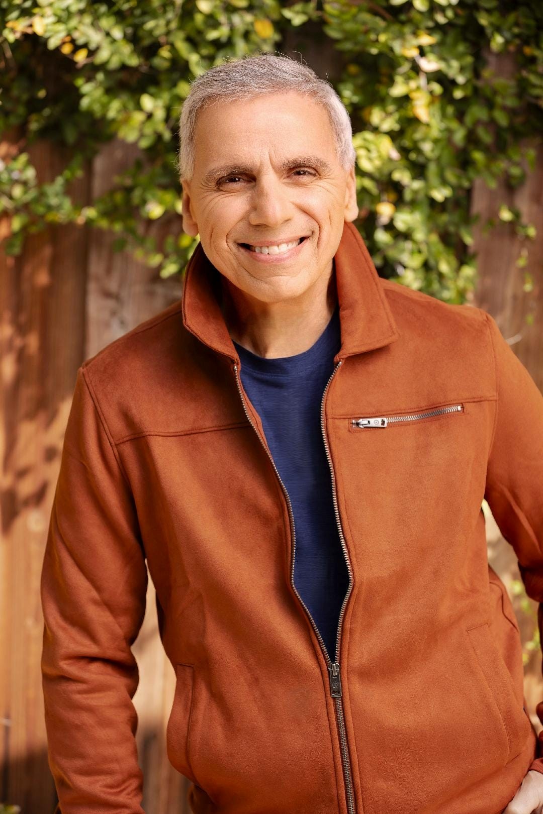 Herbie J Pilato wearing a rust-colored jacket outdoors