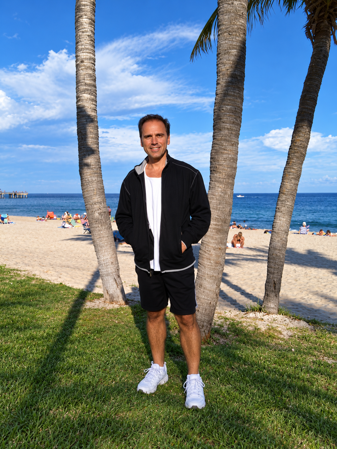 Herbie J Pilato standing among palm trees by the beach in Florida