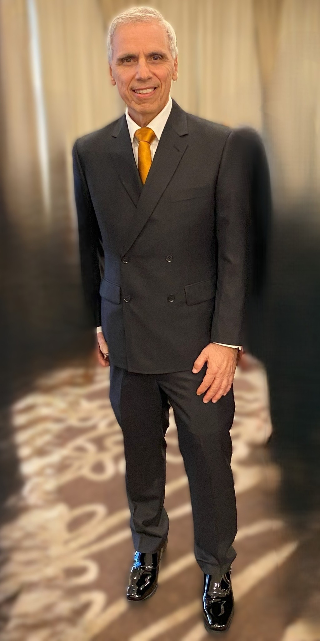 Herbie J Pilato in a black suit with a gold tie