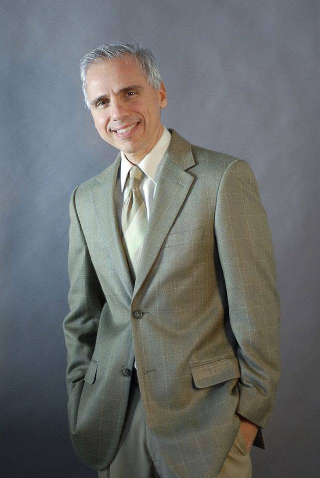 Herbie J Pilato smiling in a green suit