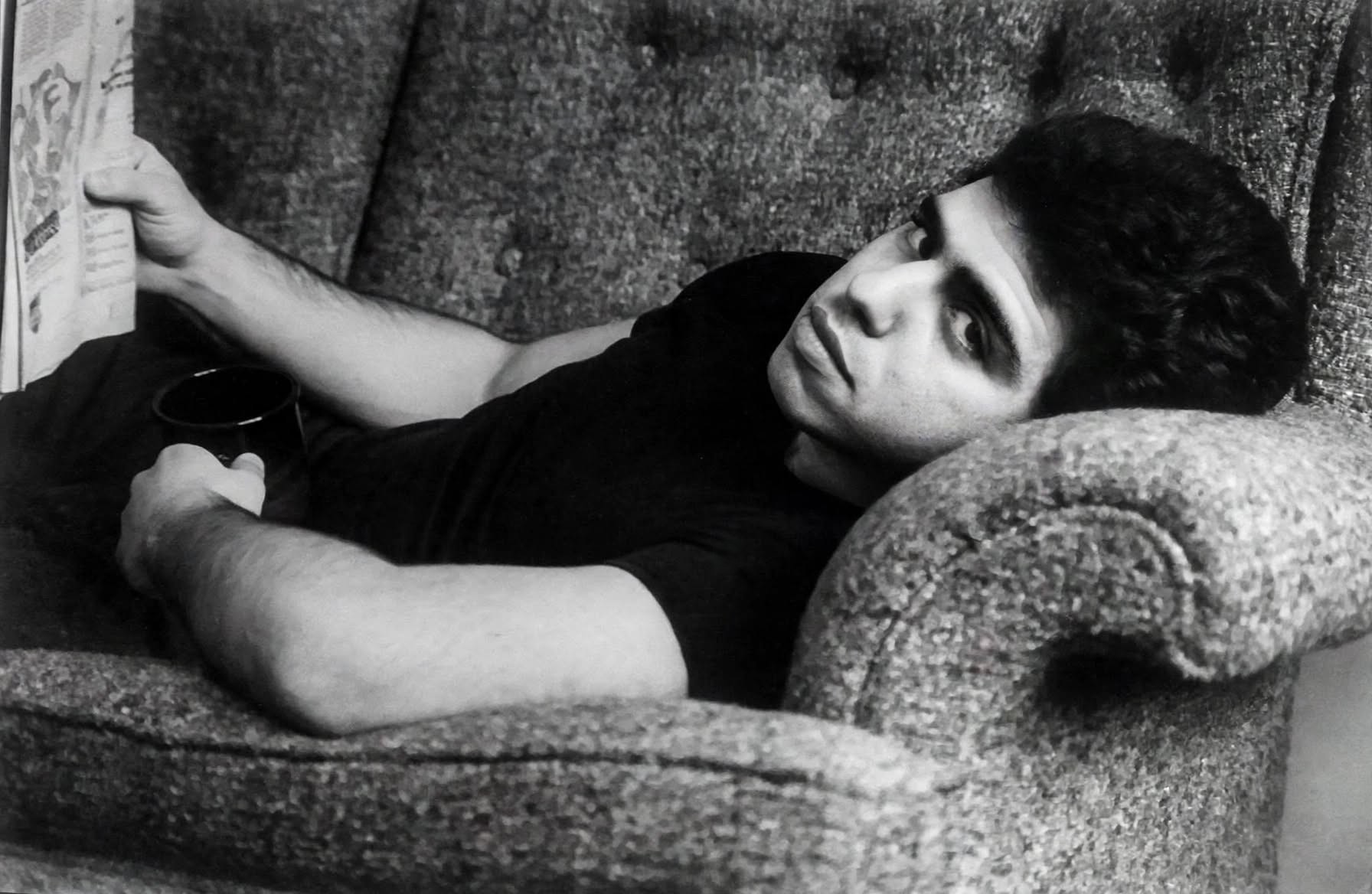 Young Herbie J Pilato reclining on a sofa in a black-and-white portrait