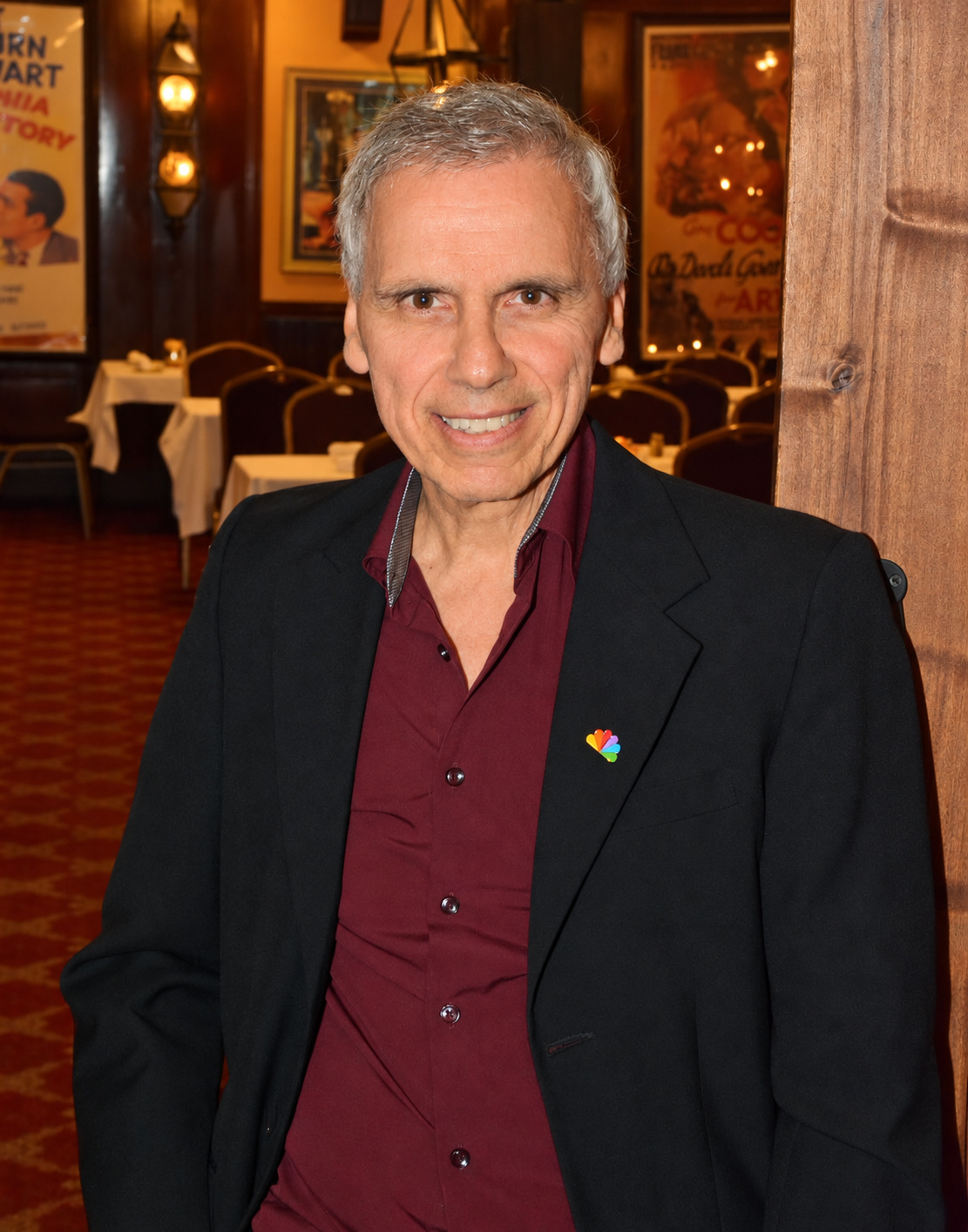 Color portrait of Herbie J Pilato wearing an NBC pin